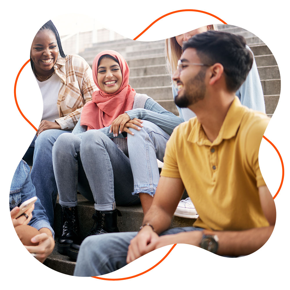 Photo of a group of young people talking sat on steps.